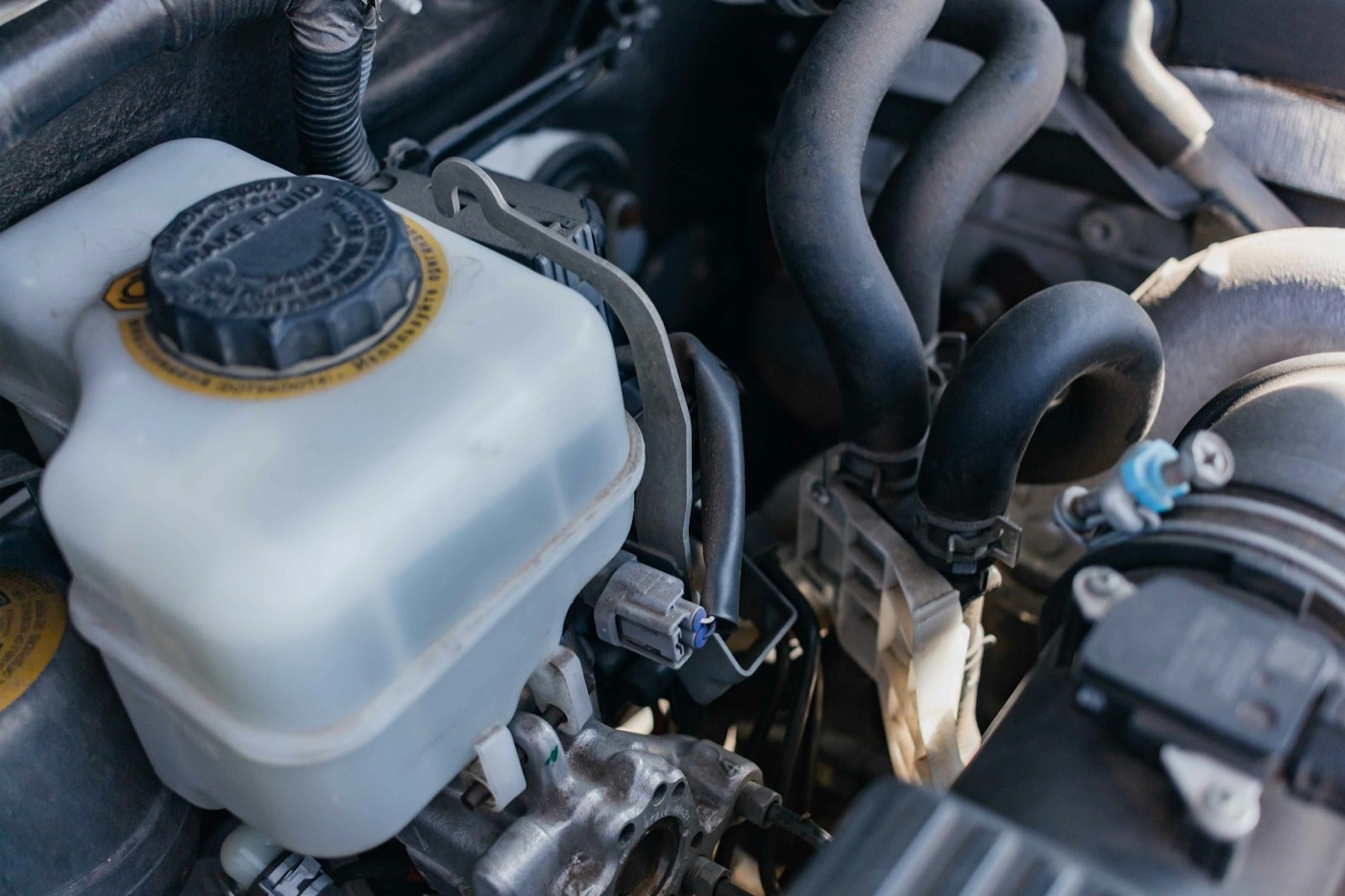 A coolant reservoir in an engine bay